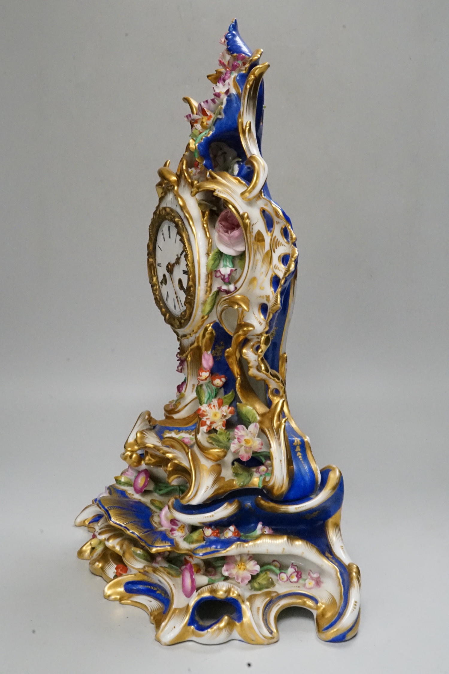 A mid 19th century French porcelain mantel clock and stand, probably Jacob Petit, 43cm tall
